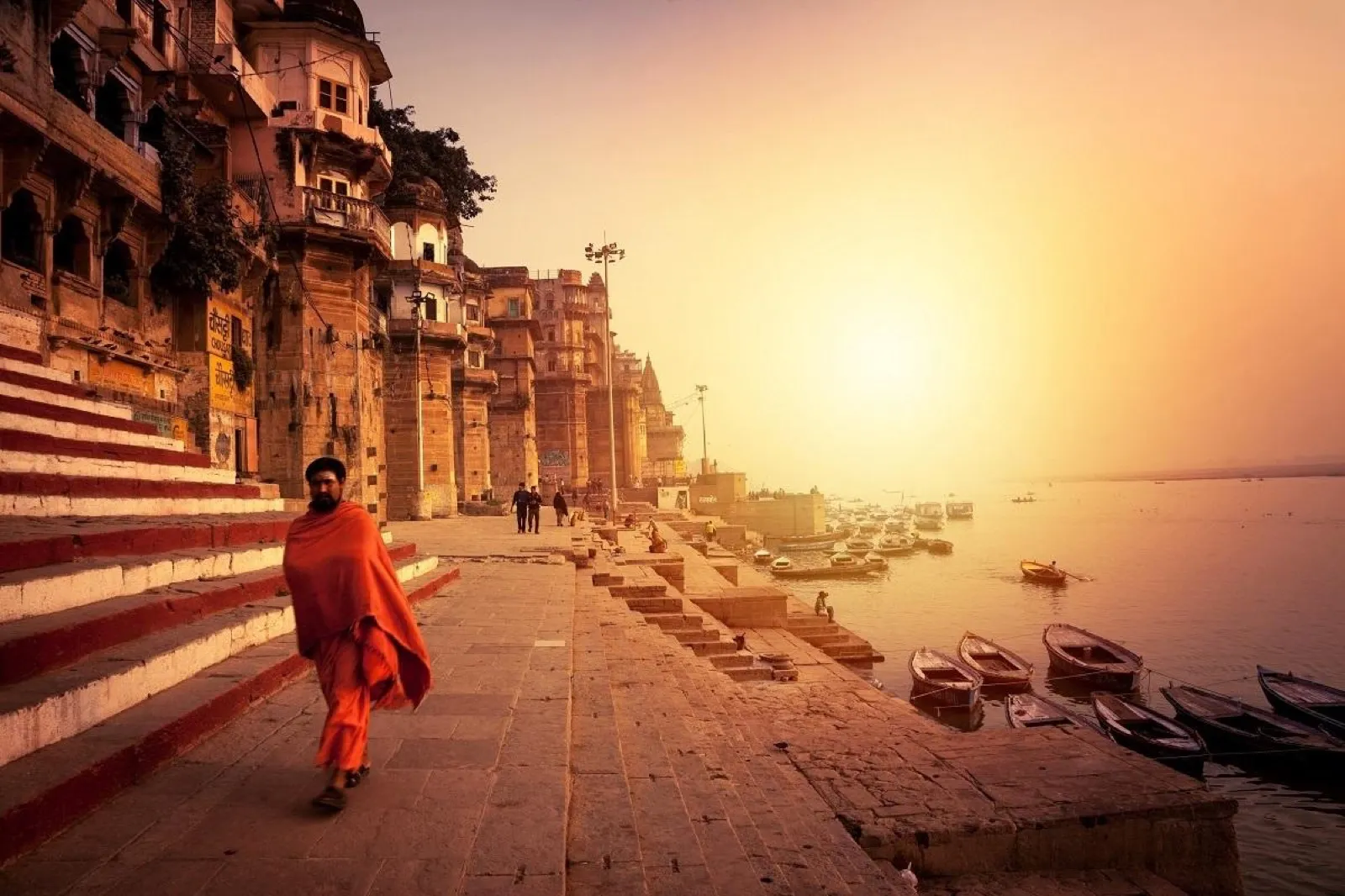 A sadhu walking the ghats of the Ganga at sunrise